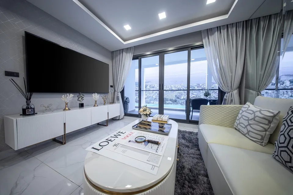 2-bedroom show unit living area with floor-to-ceiling windows